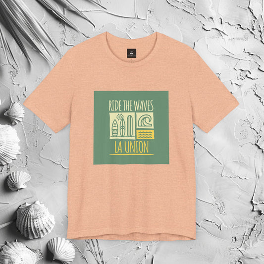Ride The Waves La Union Graphic T-Shirt | Modern Filipino Clothing | HINIRANG. Embrace the surf culture with our Ride the Waves La Union T-Shirt, a must-have from a Filipino clothing brand that celebrates the thrill of La Union’s iconic waves. Designed for those who live for the sea, sun, and adventure.
